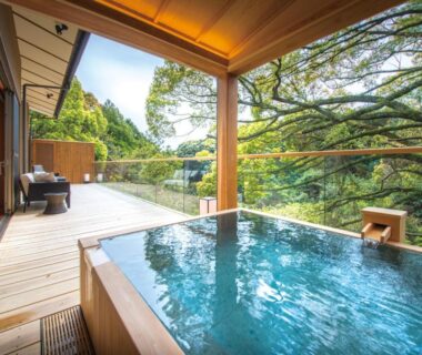 Wooden outdoor bath on deck overlooking lush trees, ABBA Resorts Izu Zagyosoh, Shizuoka