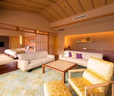 Spacious tatami room with seating, beds and shoji screens at ABBA Resorts Izu in Shizuoka