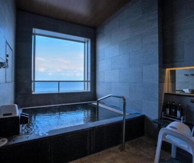 Indoor tiled bath with ocean view at AMANE resort SEIKAI, Ōita, Kyūshū, Japan