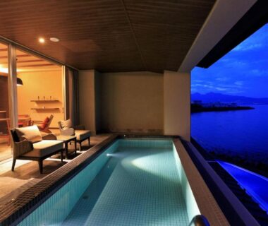 Tiled soaking pool and seating opening to waterfront at AMANE resort SEIKAI Oita