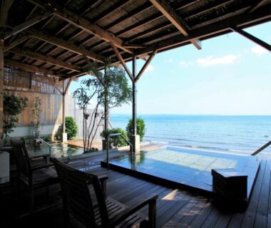 Outdoor wooden deck with soaking pool overlooking sea at AMANE resort SEIKAI Ōita Kyūshū Japan