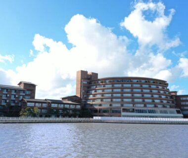 Multi-story waterfront facade at APA Hotel and Resort Kaga Katayamazu Onsen Kasuikyo in Ishikawa