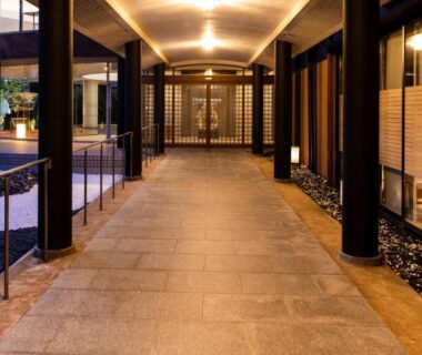 Covered stone walkway with wooden pillars at APA Hotel and Resort Kaga Katayamazu Onsen Kasuikyo, Ishikawa, Japan