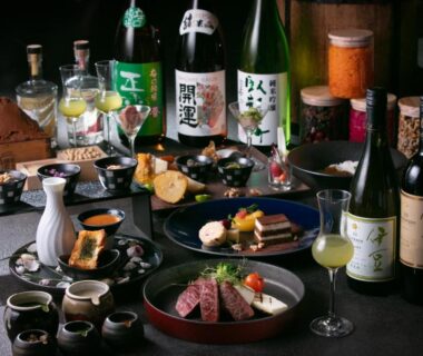 Assorted plated Japanese dishes with sake bottles and cups at AWA Nishi-Izu Shizuoka