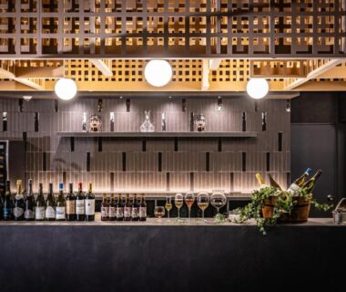 Bottles and glassware on a bar counter with hanging lights, AWA Nishi-Izu, Shizuoka, Chūbu, Japan