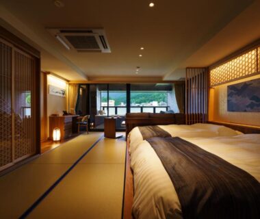 Tatami room with twin beds and shoji screens at Aburaya Tousen, Nagano, with seating and garden view