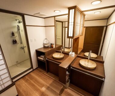 Double wooden sinks, enclosed shower and shoji screen in Aburaya Tousen bathroom, Nagano Chūbu