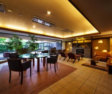 Spacious ryokan lounge with seating and garden view at Aburaya Tousen in Nagano, Chūbu
