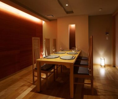 Low-lit wooden dining room with table and chairs at Aburaya Tousen in Nagano, Chūbu