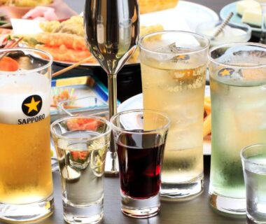 Various glasses including Sapporo beer and mixed drinks on dining table at Aishinkan, Iwate, Tōhoku