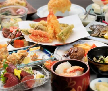 Assorted sashimi, tempura and small lacquer bowls for a traditional multi-course meal at Aishinkan, Iwate