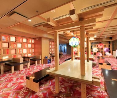 Spacious dining area with low tables and wooden beams at Aishinkan, Iwate, Tōhoku