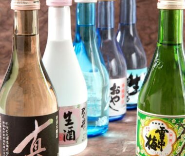 Assorted sake bottles on wood at Akakura Hotel in Chūbu, Niigata