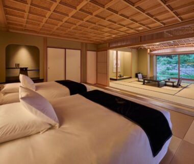 Tatami room with twin beds, shoji screens and garden view at Akazawa Geihinkan, Shizuoka