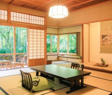 Tatami room with low table, shoji screens and garden view at Arai Ryokan in Shizuoka, Chūbu