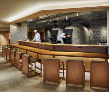 Chefs working behind a wooden counter with stools at Arima Grand Hotel, Hyōgo, Kansai