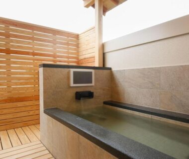 Stone tub with enclosed wooden fence and deck at Arima Hot Spring Ryokan Kotori, Hyōgo, Kansai