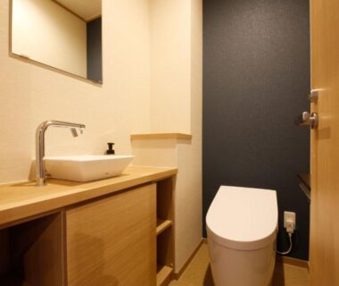 Compact modern bathroom with wooden vanity and toilet at Arima Hot Spring Ryokan Kotori, Hyōgo, Kansai