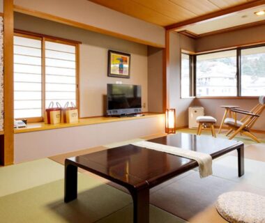 Japanese tatami room with low table, shoji screens, TV and window seating at Arima Hot Spring Ryokan Kotori