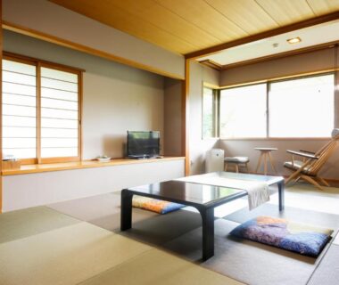 Tatami room with low table, zabuton cushions, shoji screens, and window seating at Arima Hot Spring Ryokan Kotori in Hyōgo