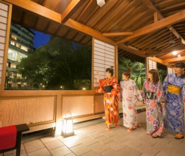 Women in yukata walking along wooden covered corridor at Gekkoen Yugetsusanso, Arima Onsen, Hyōgo