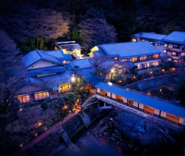 Aerial night view of Arima Onsen Gekkoen Yugetsusanso ryokan buildings and connecting bridge in Hyōgo