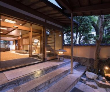 Stone steps and wooden veranda leading to lit ryokan entrance at Arima Onsen Gekkoen Yugetsusanso in Hyōgo Kansai