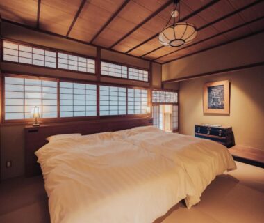 Tatami room with futon bedding, shoji screens and wooden beams at Arima Onsen Tocen Goshobo Hyōgo