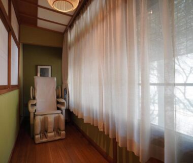 Massage chair by sheer curtain windows at Arima Onsen Tocen Goshobo Hyōgo