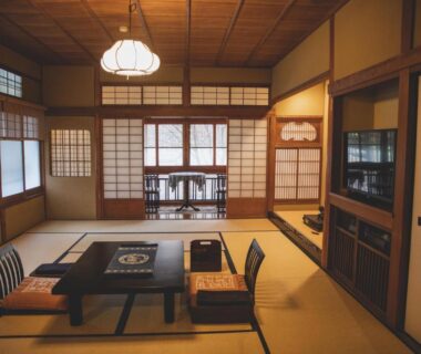Traditional tatami room with low table, zaisu chairs, shoji screens and warm wooden ceiling at Arima Onsen Tocen Goshobo, Hyōgo