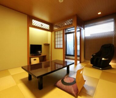 Traditional tatami room with low table, zabuton cushion, shoji screens and a massage chair at Arima Royal Hotel, Hyōgo