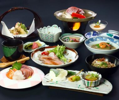 Assorted traditional Japanese course dishes on small plates and lacquerware at Aritaya Ryokan, Nagano