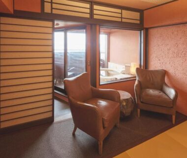 Tatami room with shoji screens and seating at Arujisu ryokan in Shizuoka, Chubu, Japan