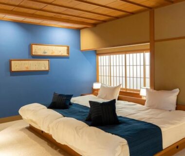 Tatami room with low twin beds, shoji screens and blue accent wall at Asadaya, Ishikawa, Chūbu, Japan