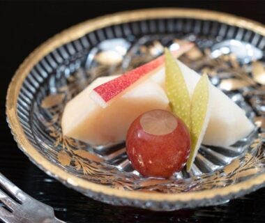 Sliced pear and grape on a decorative ceramic plate at Asadaya ryokan in Ishikawa