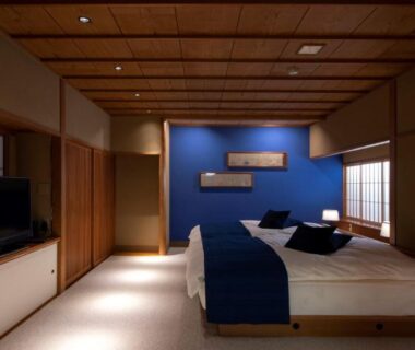 Tatami-style room with low twin beds, shoji screens and seating at Asadaya, Chūbu region, Ishikawa, Japan