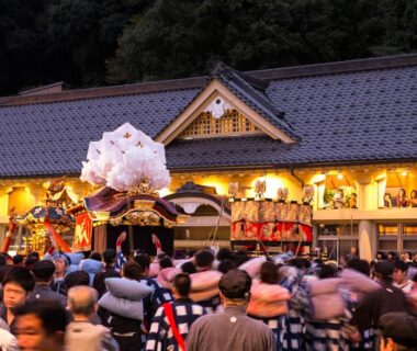 Crowd at a traditional festival procession with portable shrine outside Asagiriso ryokan in Hyōgo, Japan