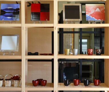 Wooden cubby shelves displaying lacquerware and ceramics at Asahikan in Nagano, Chūbu, Japan