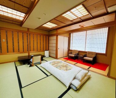 Futon on tatami floor, shoji screens and low seating at Asanoya in Hyōgo, Kansai