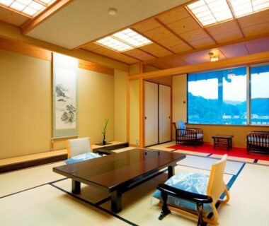 Tatami room with low table, shoji screens and seating by window at Asanoya in Hyōgo, Kansai
