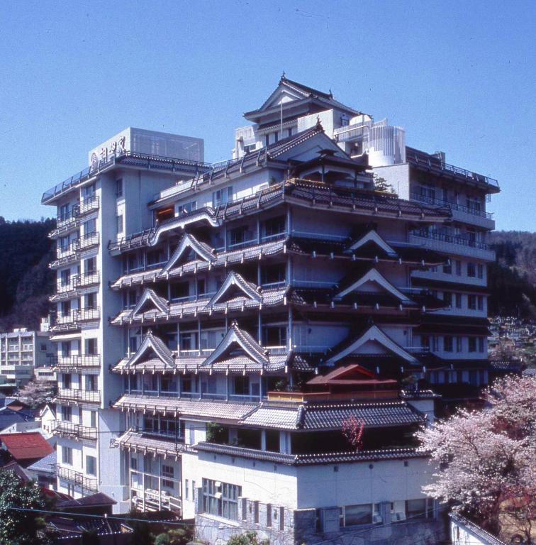 Gabled multi-storey ryokan Asanoya Hyōgo Kansai Multi-storey ryokan with traditional gabled roofs and cherry blossoms visible in Hyōgo, Kansai