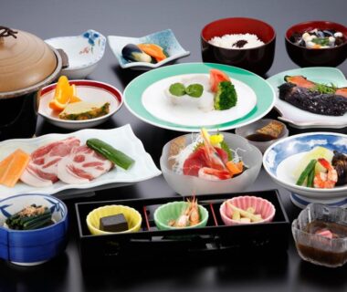 Assorted Japanese small dishes and bowls arranged on lacquer tray at Ashinomaki Prince Hotel, Fukushima