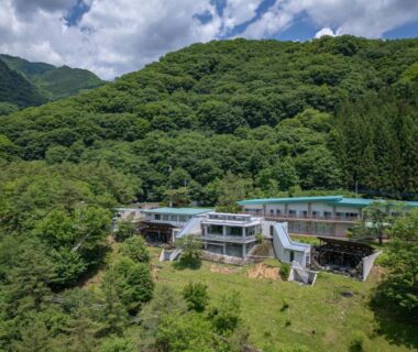 Ryokan buildings on forested mountain slope at Ashionoyado Kajika, Tochigi, Japan
