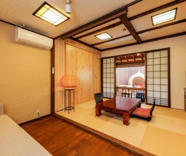 Tatami room with low wooden table, shoji screens and seating at AsoTsuruya in Kumamoto, Kyushu