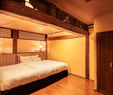 Low bed, shoji screens and exposed beams in AsoTsuruya guest room, Kumamoto