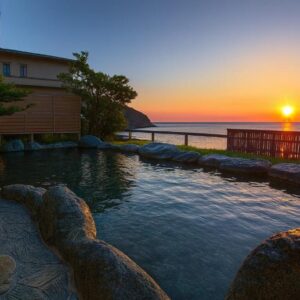 Outdoor stone onsen at sunset overlooking the sea, Atagawakan, Shizuoka
