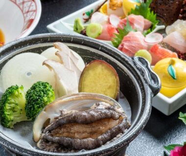 Abalone and vegetables simmering in a hot pot with sashimi platter at Atagawakan, Shizuoka, Chūbu, Japan