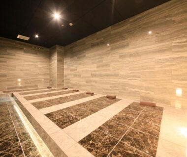 Indoor marble bathing room with recessed stone platforms at Atami Fuga, Chūbu, Shizuoka, Japan