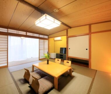 Tatami room with low table and shoji screens at Atami Fuga in Shizuoka, Chūbu, Japan