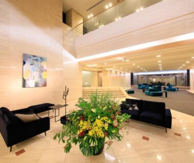 Spacious marble-floored lobby with sofa seating and floral centerpiece, Atami Fuga ryokan, Shizuoka, Chūbu, Japan